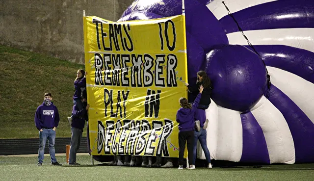 Port Neches-Groves students holding the run-through banner before a football game