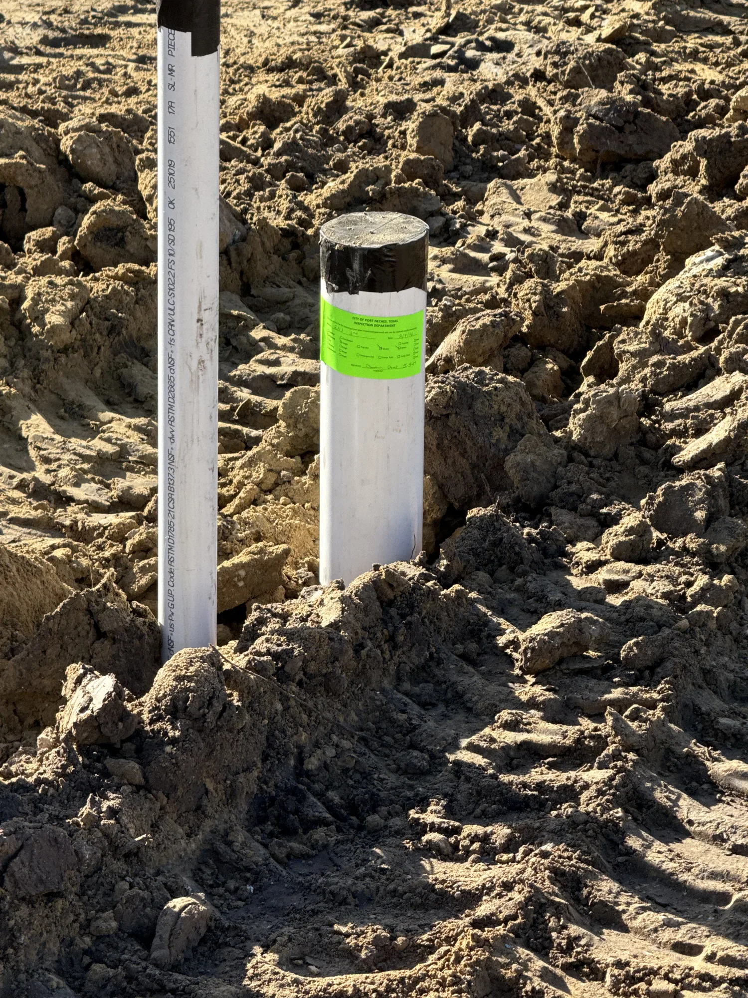 Commercial plumbing rough-in stub marked on site in Port Neches, TX