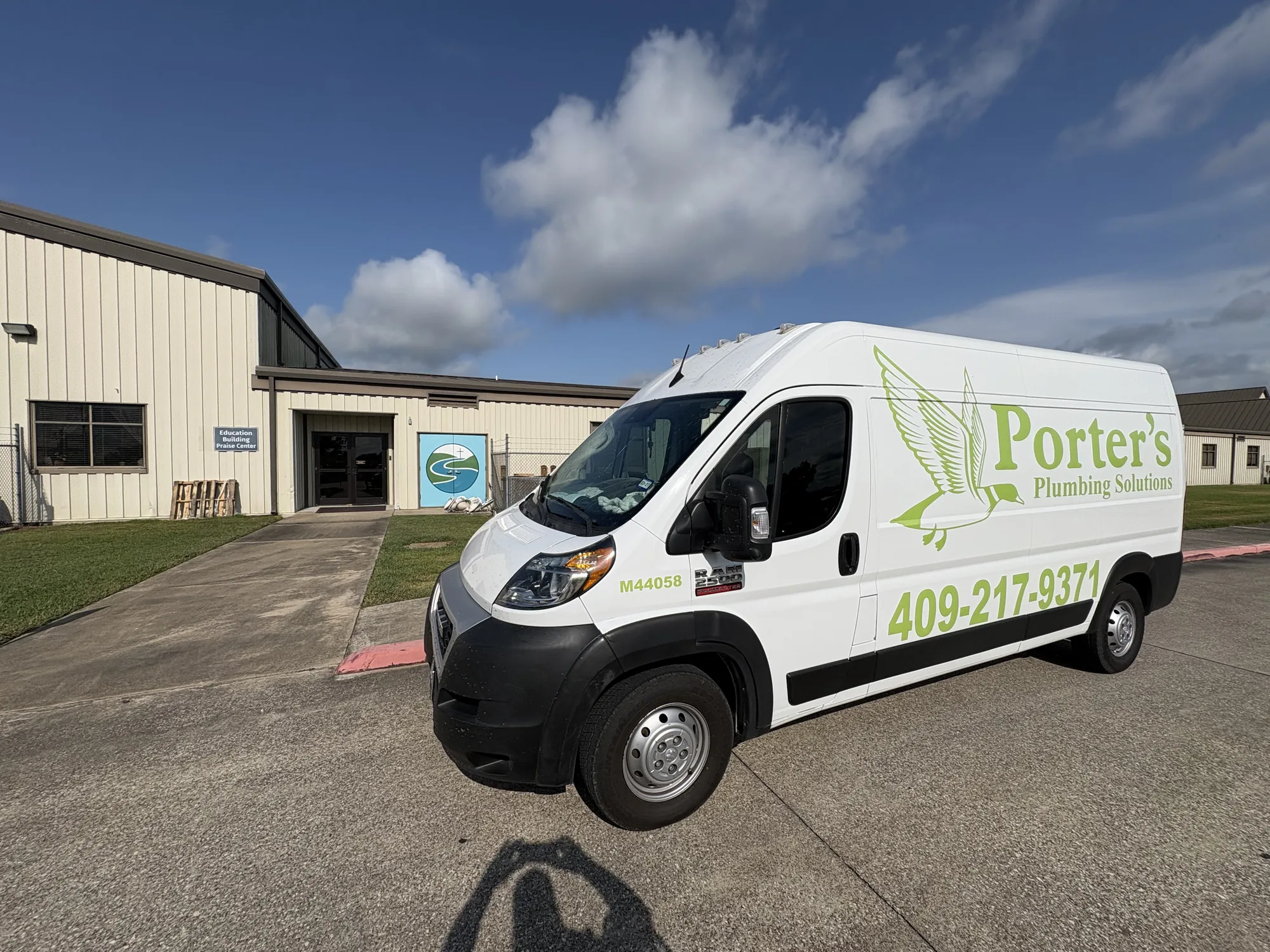Service van at the Wesley Praise Center education building for a stopped-up AC drain in Beaumont, TX