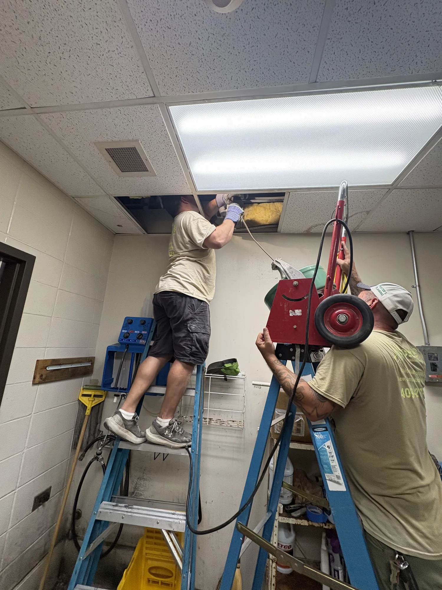 Drain machine feeding cable into a stopped-up AC condensate line at a Beaumont, TX church