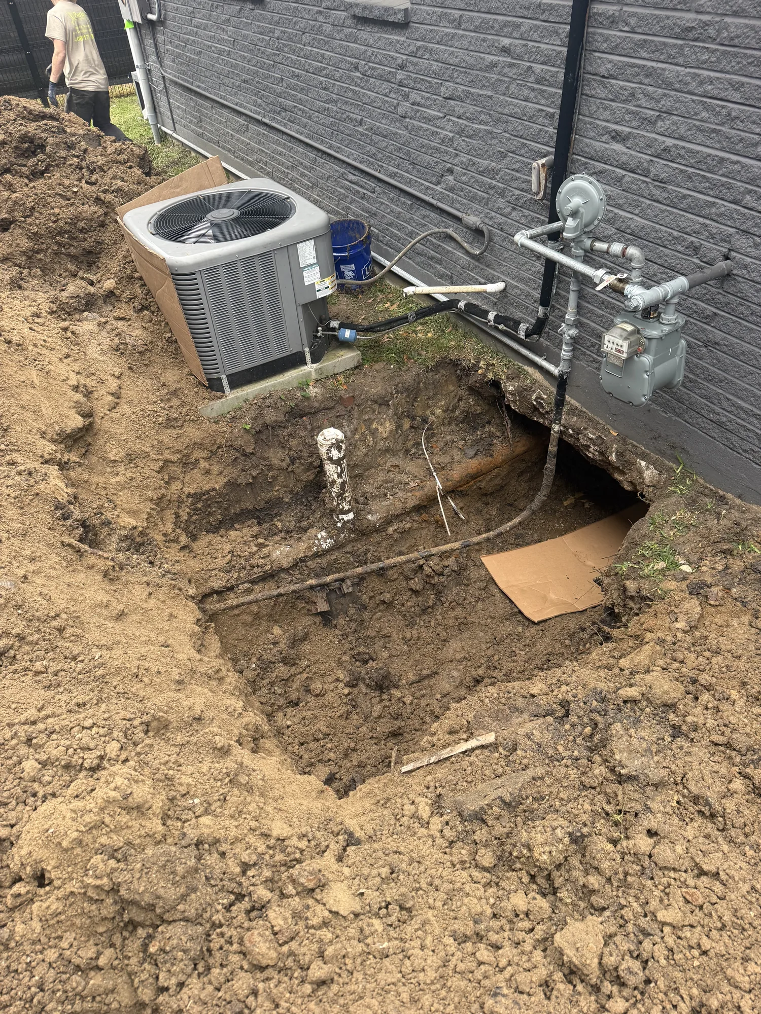 Exterior excavation for under-slab plumbing work at a Port Neches, TX home
