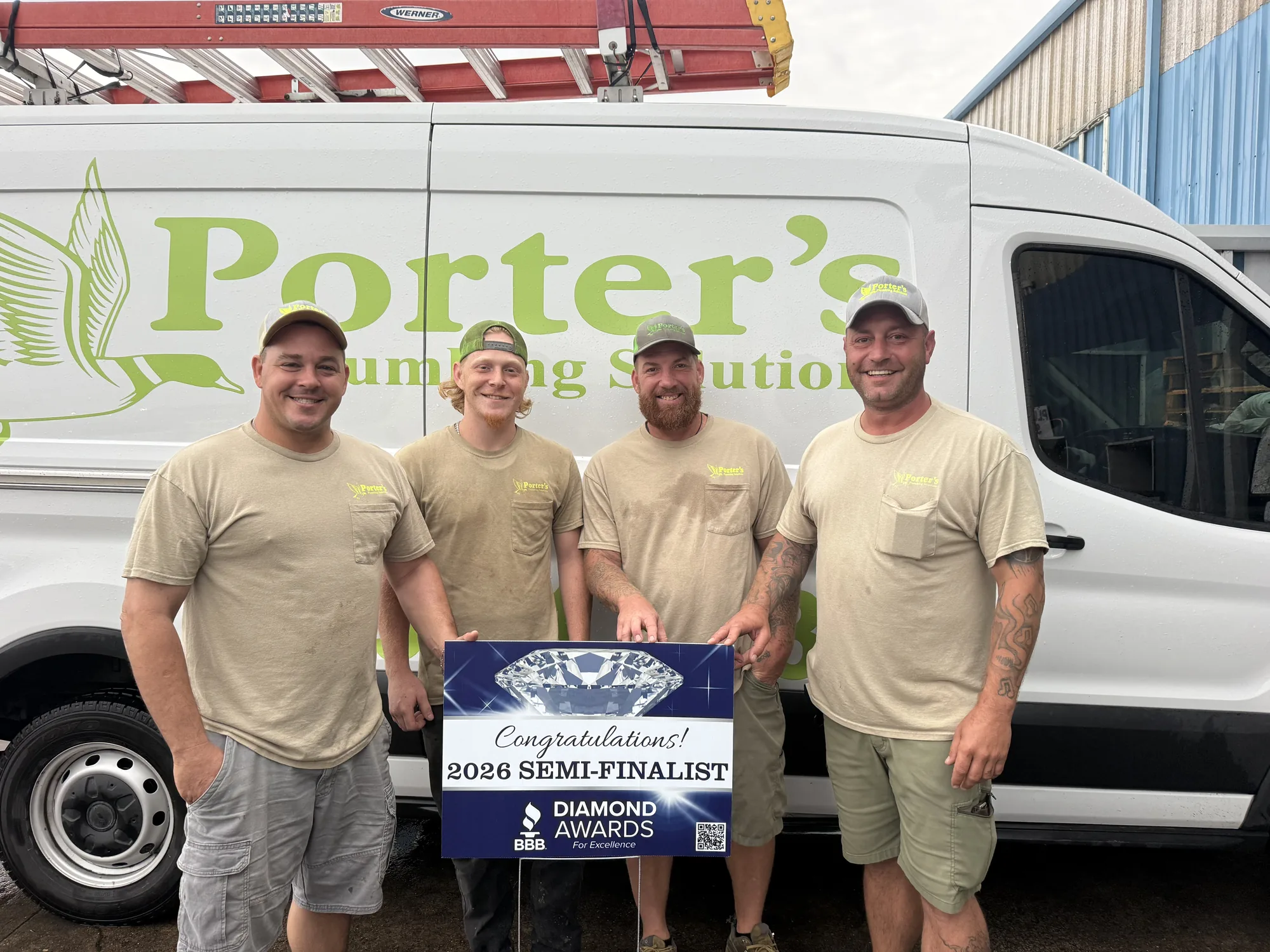 The Porter's Plumbing Solutions crew with their BBB Diamond Awards semi-finalist banner