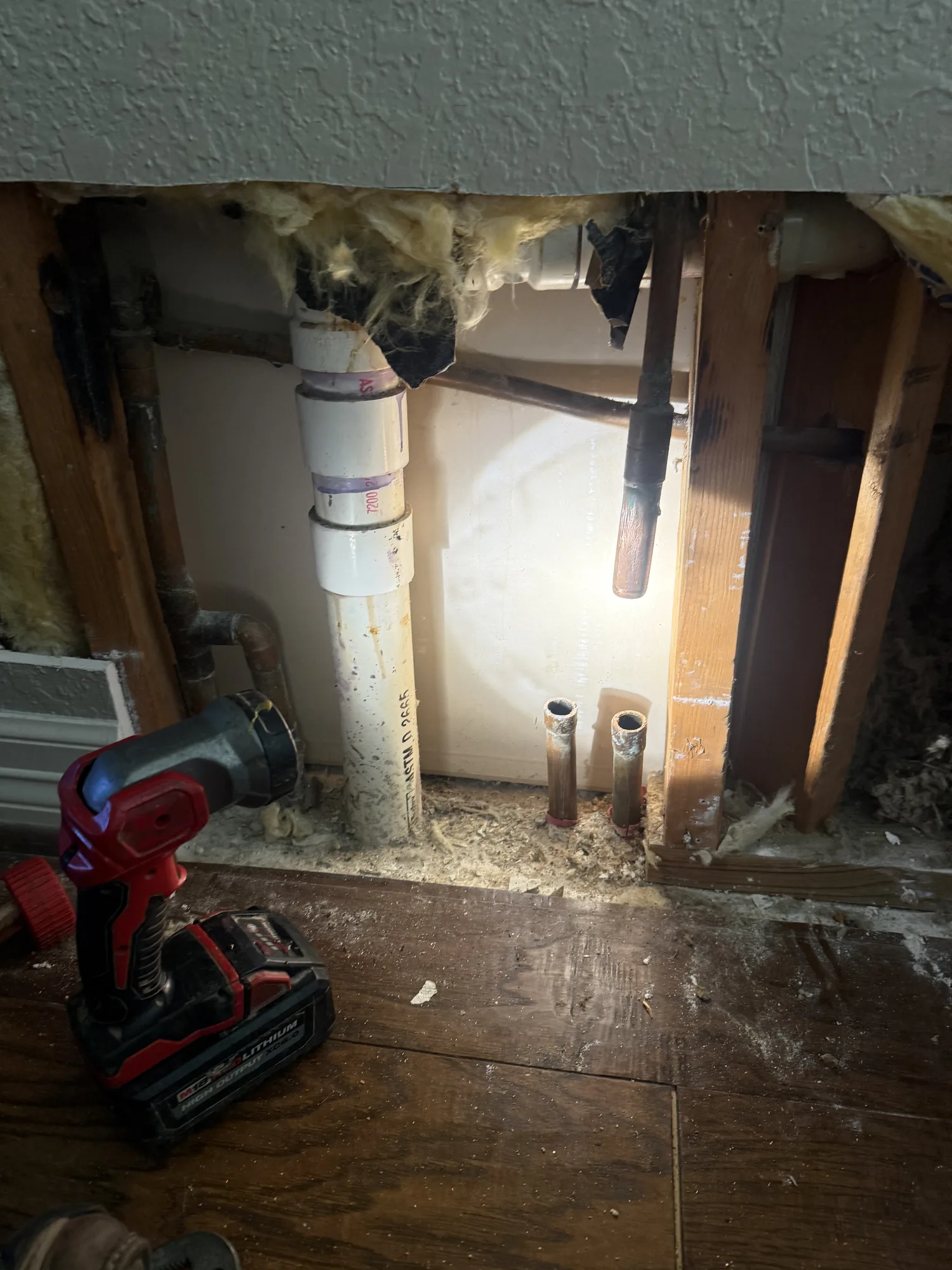 Slab leak repair: wall opened to access and reroute a failed under-slab line in Nederland, TX