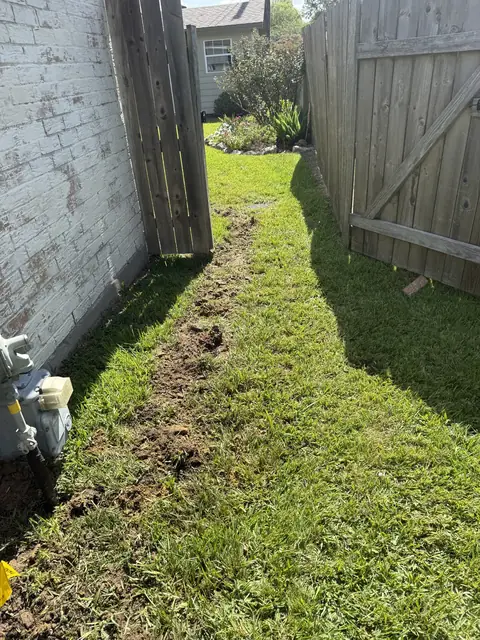 Drain line reroute trench along the side yard in Port Neches, TX