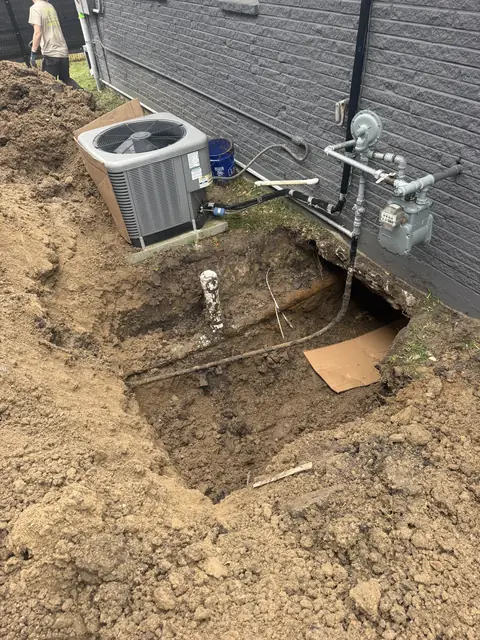 Exterior excavation for under-slab plumbing work at a Port Neches, TX home