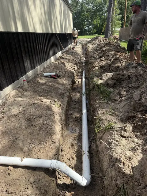 New PVC sewer line set in the trench on a Sour Lake, TX home