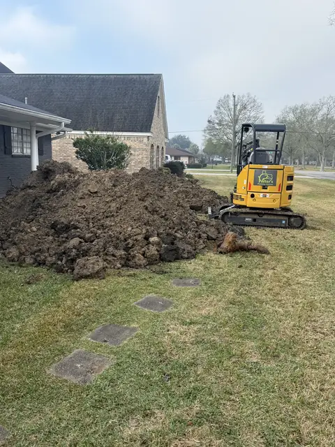 Excavator opening access beside a Port Neches, TX home