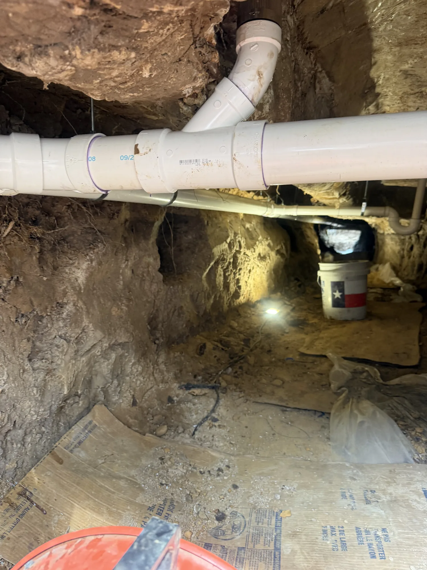 New PVC drain lines hung inside an under-slab tunnel in Beaumont, TX