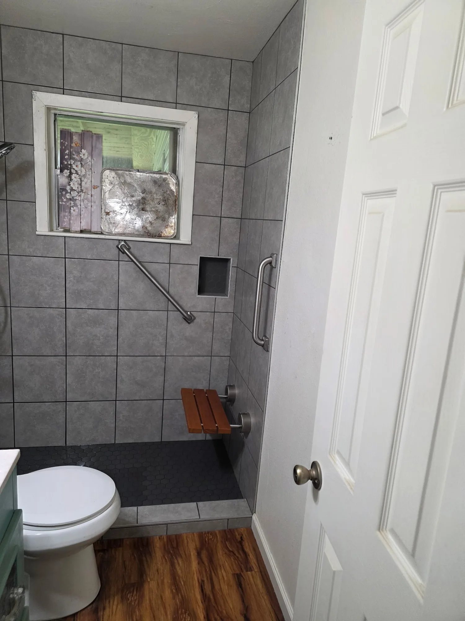 Walk-in shower with grab bars and a fold-down seat in Orange, TX
