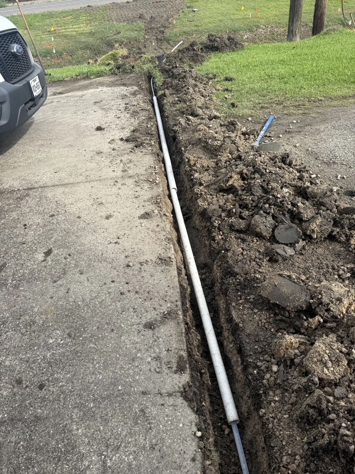 Water line trench following the walkway on a Beaumont, TX property