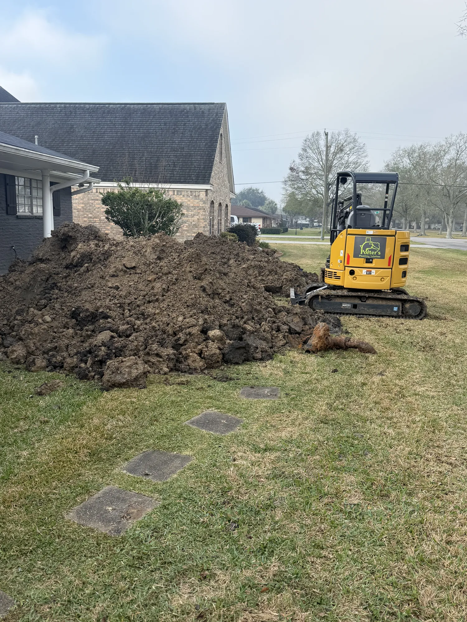 Excavator opening access beside a Port Neches, TX home